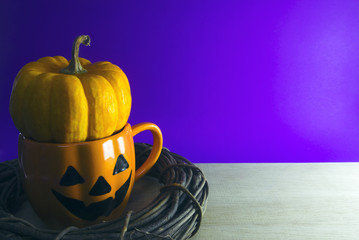 pumpkin in cup with wood vine