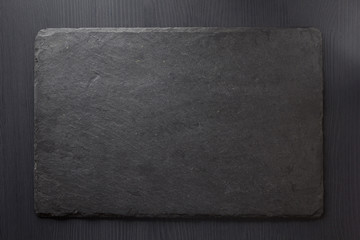 black slate stone on wooden - 122404853