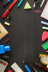 school supplies on black wood