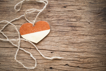 wooden heart with rope on old wooden
