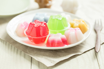 Colorful jelly on white plates on a wooden table,Local dessert Thtaland