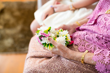 old lady hand holding flower garland