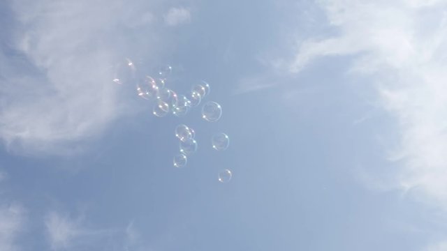 In the air soap-bubbles relaxing background slow-mo 1920X1080 HD video - Lot of transparent soap bubbles floating in the cloudy blue sky slow motion 1080p FullHD footage 