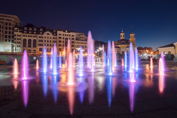 Fototapeta premium Musical fountain with colorful illumination at night with reflection. Ukraine, Kiev. Travel entartainment sightseeing background