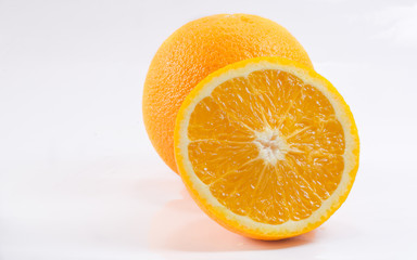 Orange cut into pieces on a white background