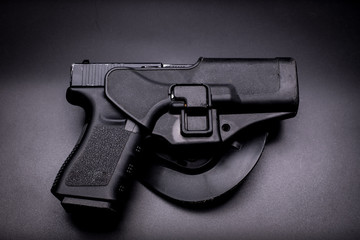 pistol in a holster in black background