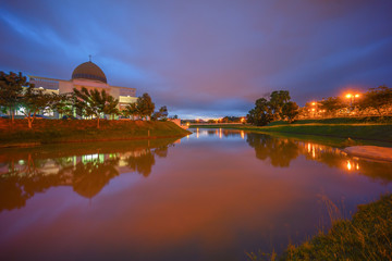 Majestic Sunset Over a Mosque by the lake with perfect reflectio
