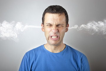 Stress and anger, angry upset man with head pressure and smoke coming out from his head