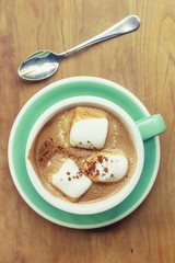 Hot chocolate with marshmallow on vintage wooden table