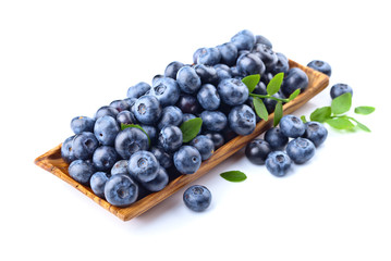 blueberries in wooden dish isolated on white