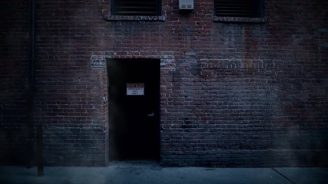 A looping scenic background of a brick building back entrance with steam rising from ground.