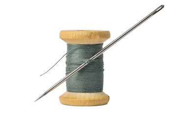 Dark thread spool and big needle isolated on white