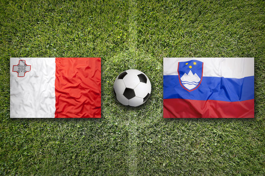 Malta vs. Slovenia flags on soccer field