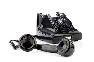 Old retro bakelite telephone. On a white background. Front focus