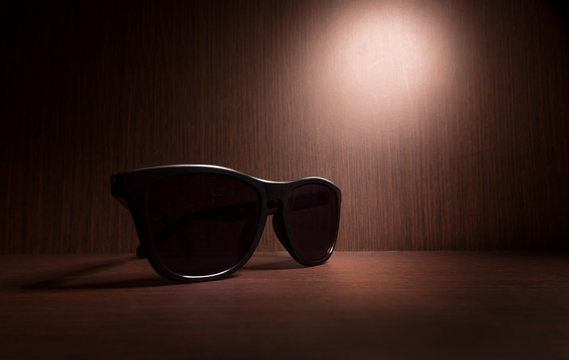 black Sunglasses on wood floor
