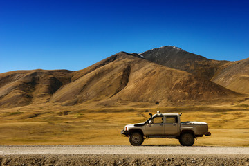 Fototapeta na wymiar Car SUV on the mountains background