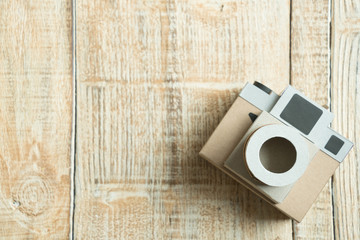 Camera paper on the wood background