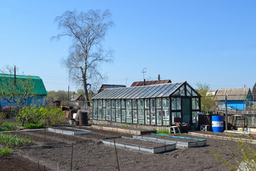 Garden plot. Greenhouse glass made by hand. Garden bed.