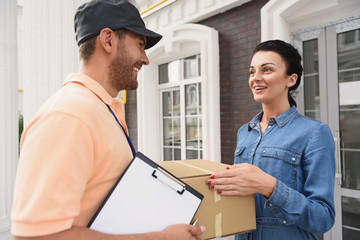Courier making delivery to beautiful woman
