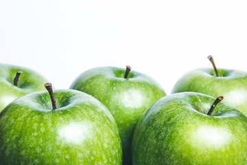 Green shiny apples isolated on white with empty copy space.