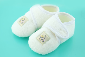 Baby shoes on light blue background