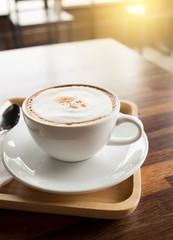 cup of coffee on restaurant terrace with afternoon sunlight