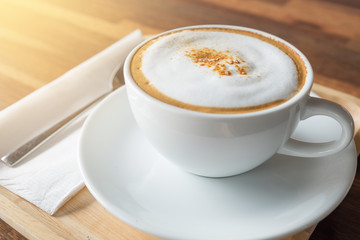 cup of coffee on restaurant terrace with afternoon sunlight