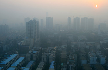 Sunrise through the smog in a modern Chinese city