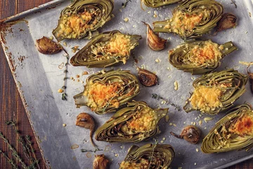 Fotobehang Artichokes baked with cheese, garlic and thyme. © tbralnina