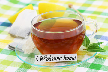 Welcome home card with cup of tea with fresh lemon
