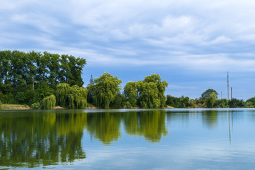 Fototapeta na wymiar Beautiful view of country lake and trees.