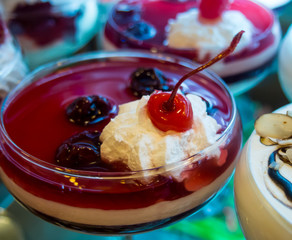 Berry mousse with whipped cream, decorated with a cherry