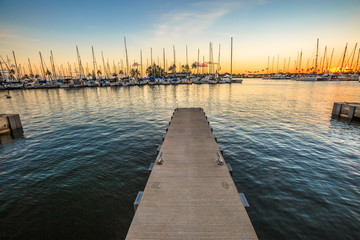 Wooden jetty in Ala Wai Harbor at sunset the largest small-boat and yacht harbor in Hawaii, situated between Waikiki and downtown Honolulu in Oahu Island, Hawaii, United States.