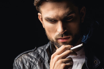 Pensive cool man smoking cigarette