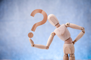 Wooden figure showing question mark symbol