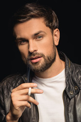 Confident bearded guy enjoying cigarette