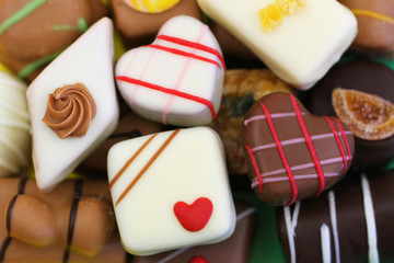 Background made of assorted milk, white and dark chocolates and pralines
