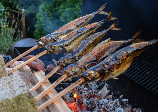 Barbecue with fish. Grilled fish on a stick