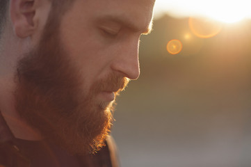 young bearded man with eyes closed