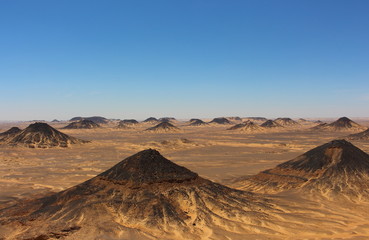 Naklejka na ściany i meble Panoramic view of the black desert mountains close to Bahariya Oasis, Egypt