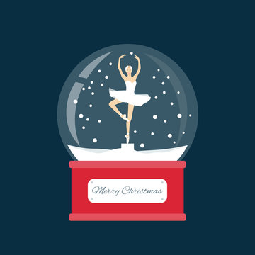 Glass ball with a ballerina dancing in the snow. New Year gift.