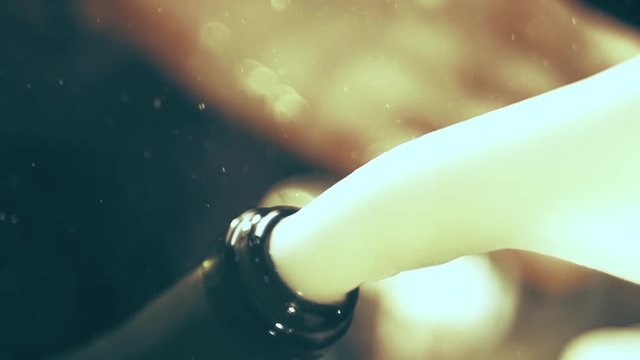 Champagne bottle exploding in slow motion