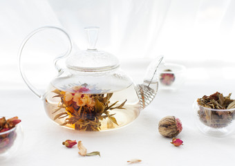 Traditional asian floral tea in a glass teapot