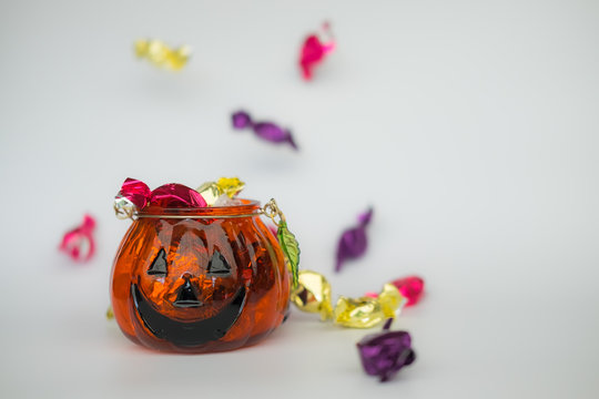 Halloween jack-o-lantern pail with spilling candy