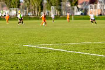 Blurred soccer players playing amateur soccer match