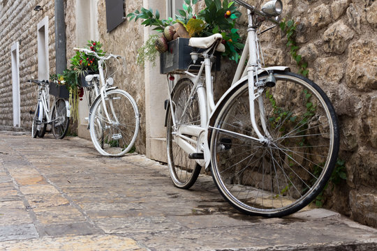 White bicycles as a decoration in an old stone fortress