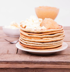 Fototapeta na wymiar Pancakes with braised apples and mascarpone cheese