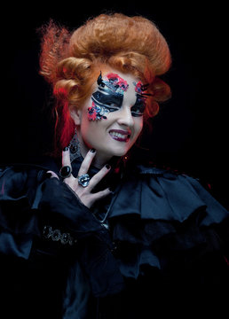 Gothic redhair witch. Dark woman. Halloween picture.