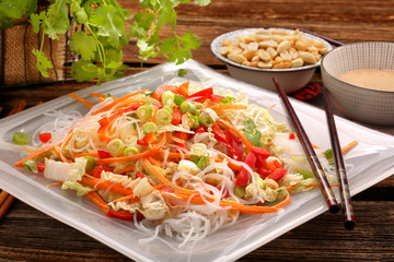 Fresh healthy salad with rice noodles and nuts