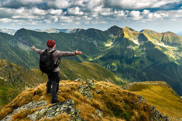 Hiker with backpack on mountains